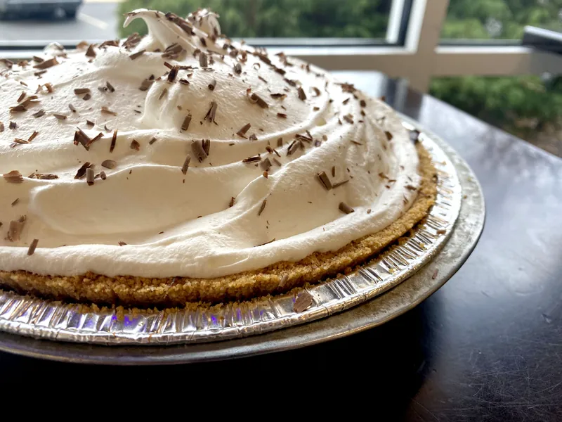 Chocolate cream pie with whipped cream and chocolate shavings