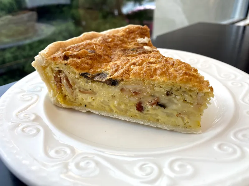 Deep-dish quiche slice with a flaky crust